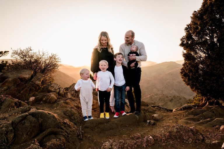 family with 4 young boys during sunset on top of lookout mountain in golden colorado for their family photography session with denver family photographer stewart photography