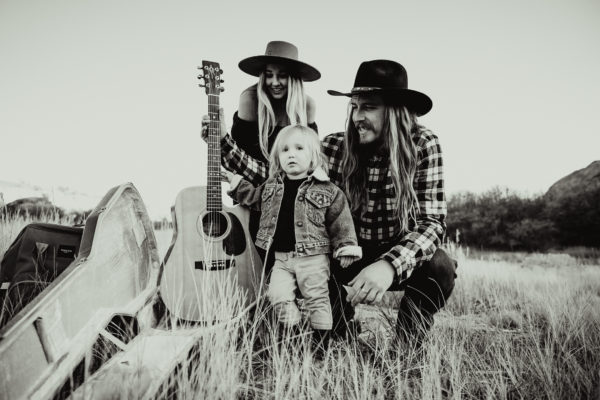 Black and white photo of a family holding a guitar