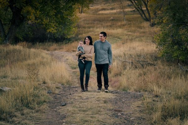 Family of 3 walking down a path during their outdoor family photography session at hildebrand ranch park with Stewart photography
